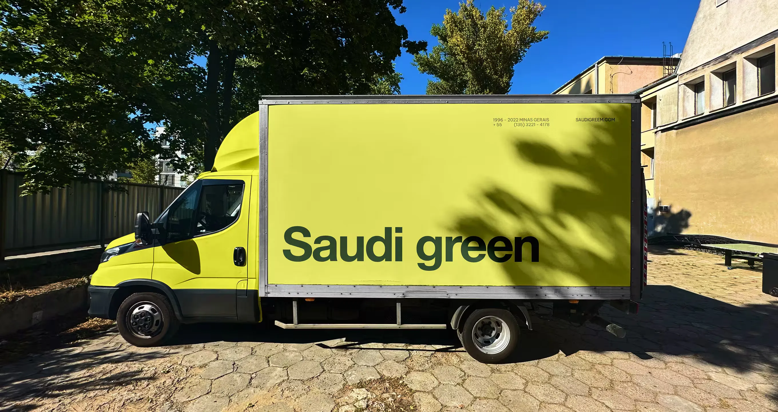 Delivery truck wrapped in the yellow Saudi Green brand identity