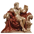 Golden statue of a bearded man seated on an ornate chair draped in red, reading a document